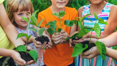 toddlers holding plants